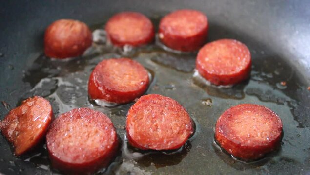 Fried sausage in the pan, cooking meat sausage