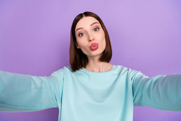 Photo portrait girl wearing blue pullover sending air kiss taking selfie isolated pastel violet color background