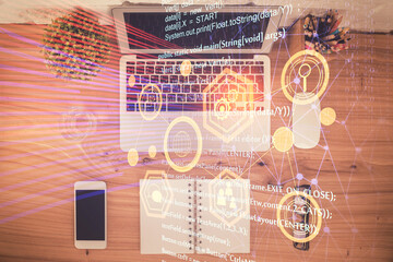 Double exposure of data theme drawing hologram over topview work table background with computer. Concept of technology.