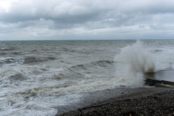 storm on the black sea, waves crashing on the shore, brown water