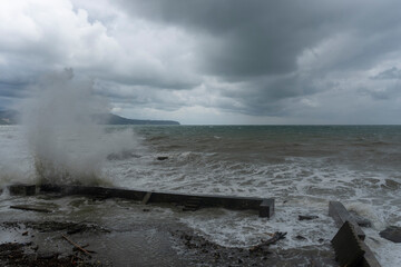 storm on the black sea, waves crashing on the shore, brown water