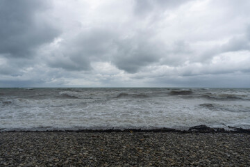 storm on the black sea, waves crashing on the shore, brown water