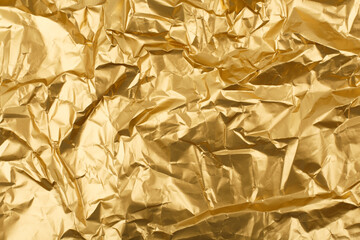 Gold crumpled paper texture background with space for text. Crumpled wrapping paper abstract...