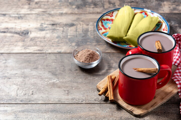 Traditional Mexican chocolate atole drink on wooden table.Copy space