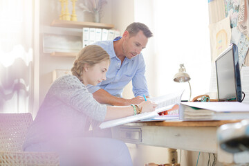 Obraz premium Father helping teenage daughter with her homework