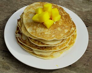 Breakfast: pancakes and fruit. Delicious breakfast on vacation in summer