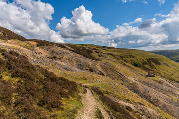 The remains of Bunton Mine with the Gunnerside Gill landscape, near Gunnerside, North Yorkshire, England, UK