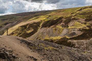 The remains of Bunton Mine with the Gunnerside Gill landscape, near Gunnerside, North Yorkshire, England, UK
