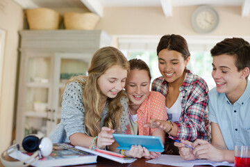 Fototapeta premium Group of smiling teenagers taking selfie in dining room