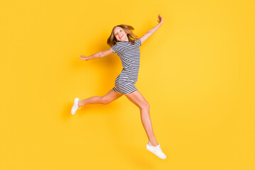 Fototapeta na wymiar Full size profile photo of nice crazy girl arms flying beaming smile look camera isolated on yellow color background