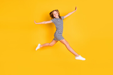 Fototapeta na wymiar Full body profile portrait of carefree excited pupil playing hands flying have fun isolated on yellow color background