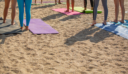 background with women doing yoga on the beach , active lifestyle