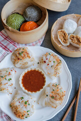 Typical Malaysian Chinese street food. Steamed Yam Ben Dumplings aka Chai Kueh. Translucent chewy skin filled with cooked turnip, carrot slices, ground dried shrimps dip in chili sauce.