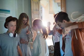 Group of teenagers dancing in living room