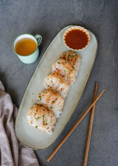 Typical Malaysian Chinese street food. Steamed Yam Ben Dumplings aka Chai Kueh. Translucent chewy skin filled with cooked turnip, carrot slices, ground dried shrimps dip in chili sauce.