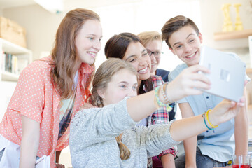 Obraz na płótnie Canvas Group of teenagers taking selfie with digital tablet