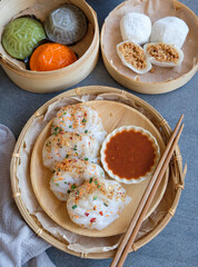 Typical Malaysian Chinese street food. Steamed Yam Ben Dumplings aka Chai Kueh. Translucent chewy skin filled with cooked turnip, carrot slices, ground dried shrimps dip in chili sauce.