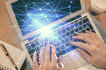 Multi exposure of man's hands typing over computer keyboard and data theme hologram drawing. Top view. Technology concept.
