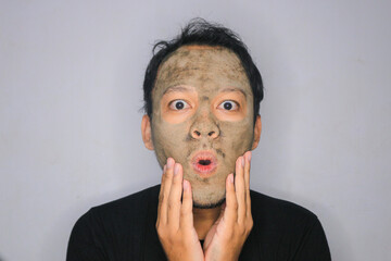 Wow Asian Man was shock and look at the camera when he use beauty face mask