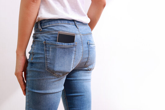 Female in jeans, smartphone in pocket