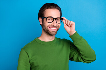 Photo of young handsome positive businessman freelancer wear spectacles green pullover isolated on blue color background