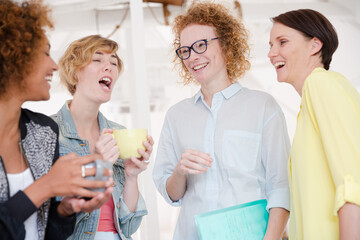 Women with coffe cup smiling in office