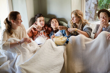 Group of teenagers sitting on sofa