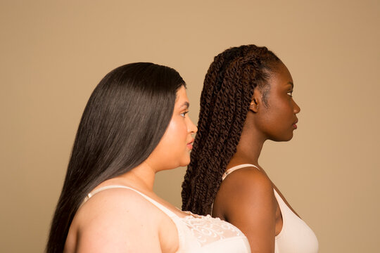 Studio shot of two young women in underwear, profile view