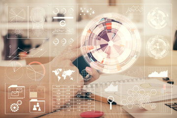 Double exposure of man's hand holding and using a digital device and data theme drawing. Technology concept.