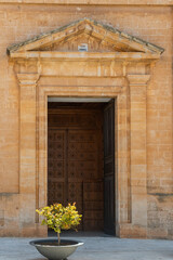 Fototapeta na wymiar Carved wooden doors of access to the entrance of the church of the Majorcan town of Campos