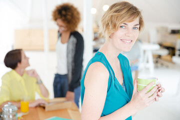Young smiling woman sitting at desk