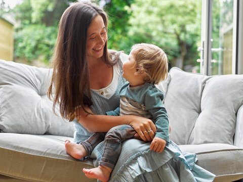 Mother with smiling baby boy in living room