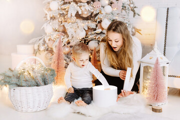 Blond Hair Young Boy and blond pretty woman enjoying Christmas Time