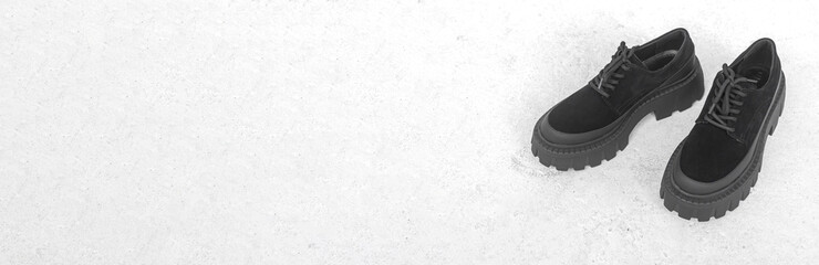 Black women boots on concrete background banner with copy space