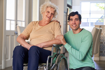 Fototapeta na wymiar Satisfied elderly woman in a wheelchair with her son