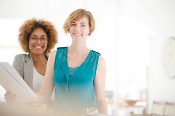 Women talking and smiling in office