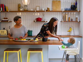 Family preparing food in kitchen