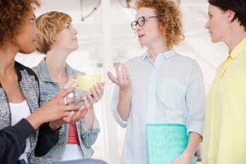 Women with coffe cup smiling in office