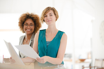 Women talking and smiling in office