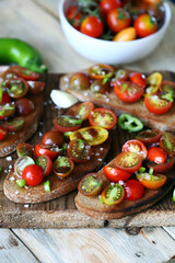 Bruschetta with mini tomatoes on a wooden surface. Healthy snack. Diet food.