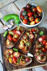 Bruschetta with mini tomatoes on a wooden surface. Healthy snack. Diet food.