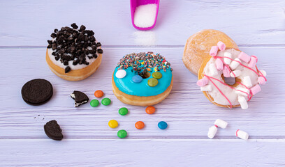 colored donuts with pieces of chocolate icing sugar and background sugar