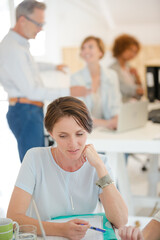 Fototapeta premium Portrait of woman sitting at desk and talking