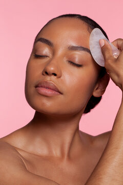 Young Woman Using Face Massager