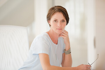 Portrait of woman sitting at desk in office