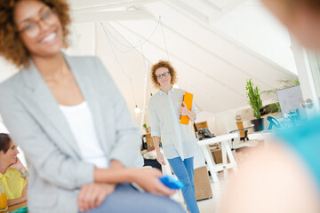 Woman walking and carrying laptop, joining colleague from office