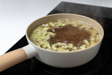 homemade boiled bitter gourd or balsam pear in pan on induction stove or cooktop, gourmet food recipe, good work from home lunch idea, shallow depth of field