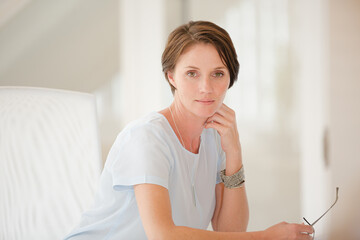 Portrait of woman sitting at desk in office
