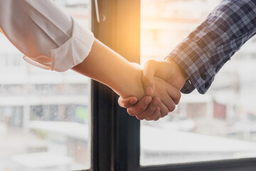 Successful asian young woman, man  partnership, team handshake together at office after project...