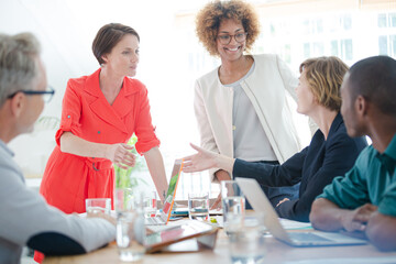 Fototapeta premium Office workers shaking hands at desk
